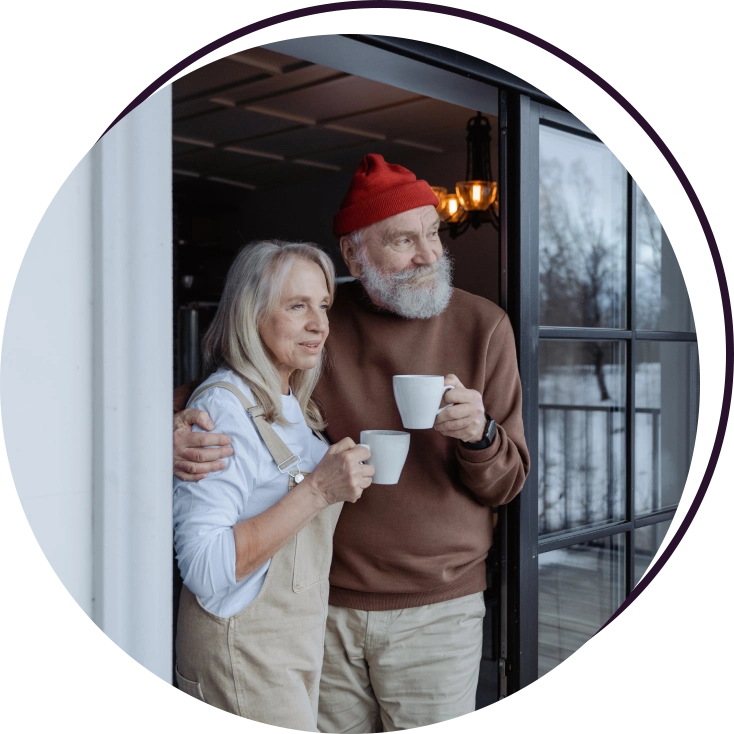 A man and woman holding coffee cups in their hands.